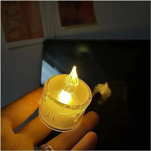 The Decor Affair 24PCS Enchanted Flameless Electric Candles: Flickering Tea Lights with Realistic Candlelight Effect, Perfect for Creating Magical Evenings.