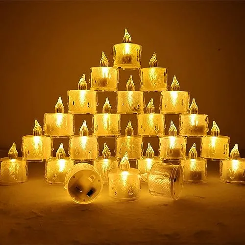 The Decor Affair 24PCS Enchanted Flameless Electric Candles: Flickering Tea Lights with Realistic Candlelight Effect, Perfect for Creating Magical Evenings.